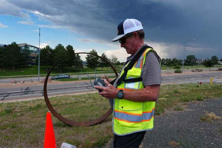 Drone pilot using a flight controller for professional aerial mapping and construction site monitoring in Colorado